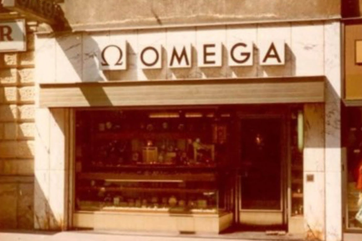 Helles, geradliniges, marmoriertes Gesch&auml;ftsportal &uuml;ber dem das Omega Logo residiert.